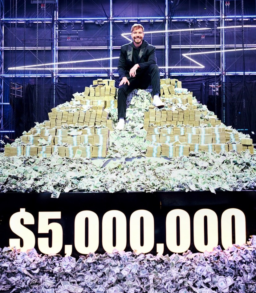 Campaign host with a multi million dollar prize display under professional blue studio lighting